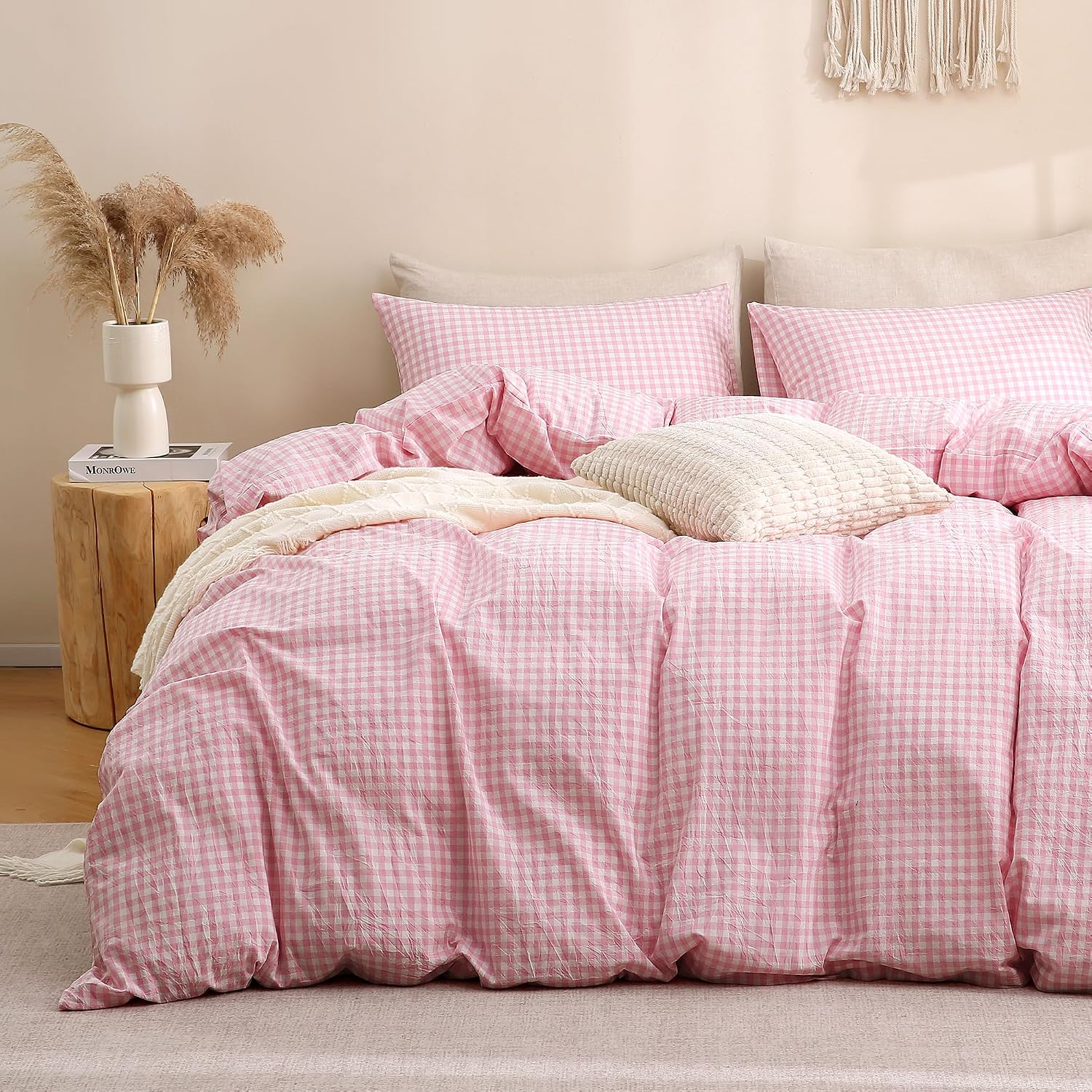 A rattan bedhead behind a pink checked gingham duvet cover and matching pillowcases