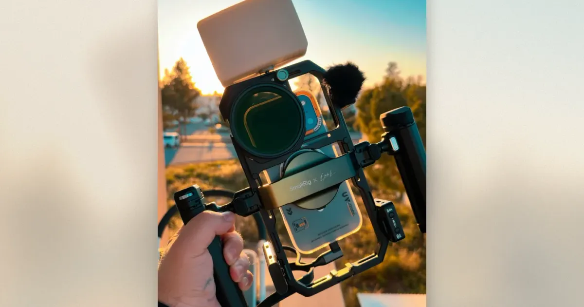 SmallRig x Brandon Li Mobile-Rig in der Hand mit Phone, ND-Filter, Funkmikrofon und LED-Panel im Sonnenuntergang