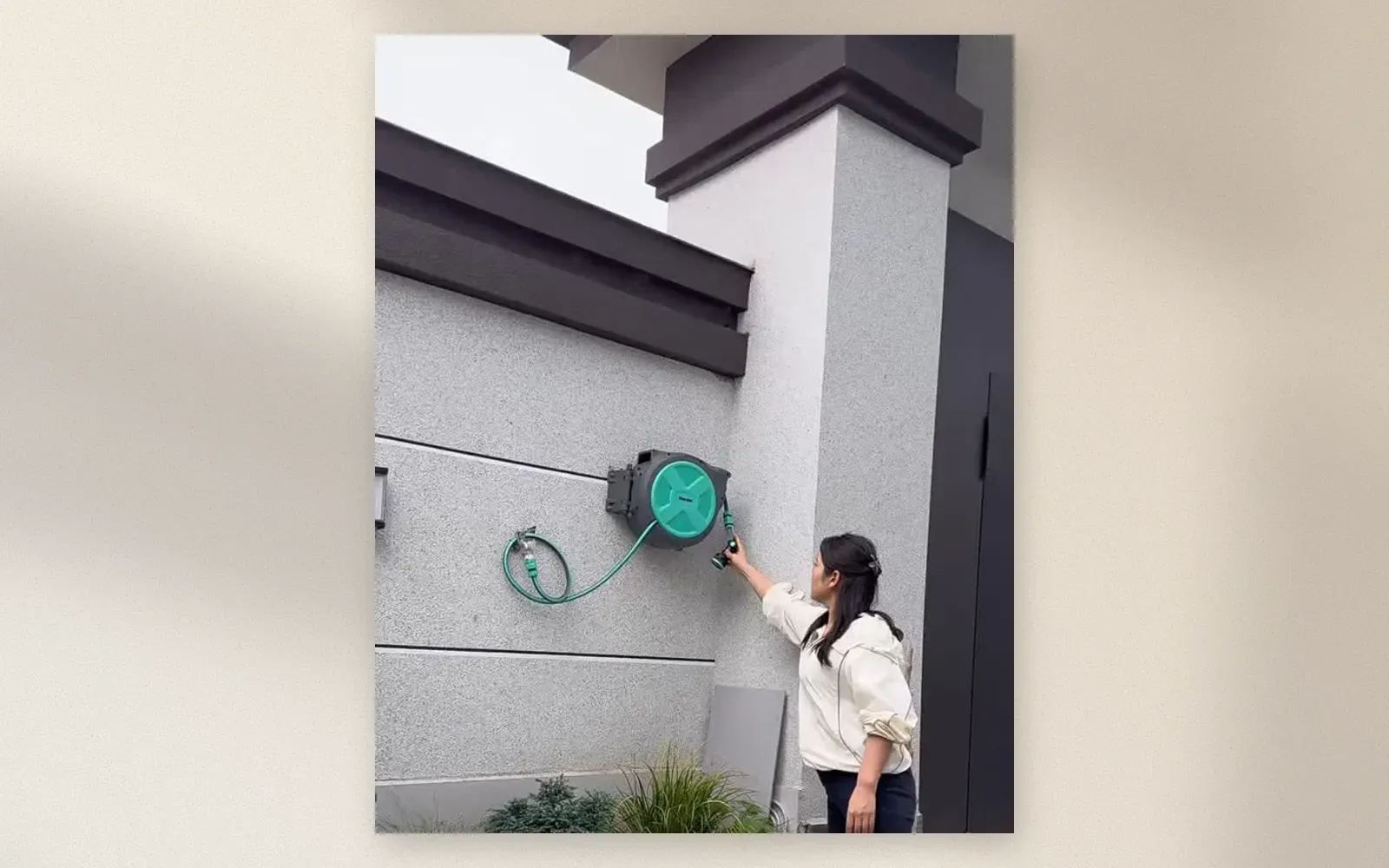 Close-up of the hose retracting into the wall-mounted box
