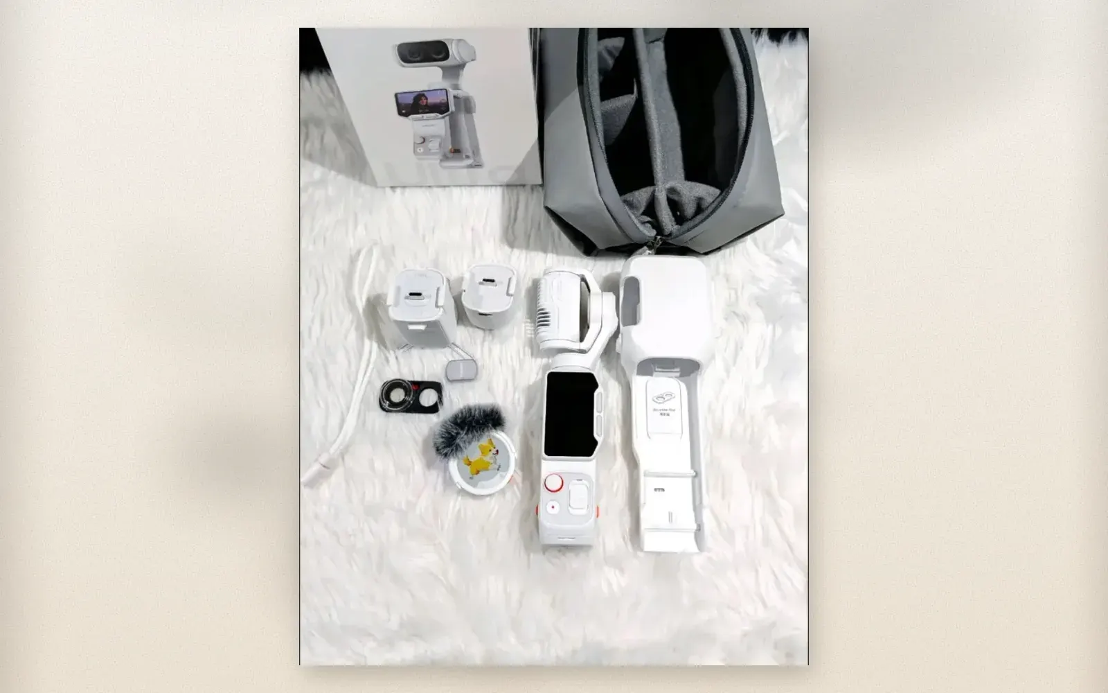 Insta360 Luna Ultra unboxing with camera, lenses, case, and accessories on white fur