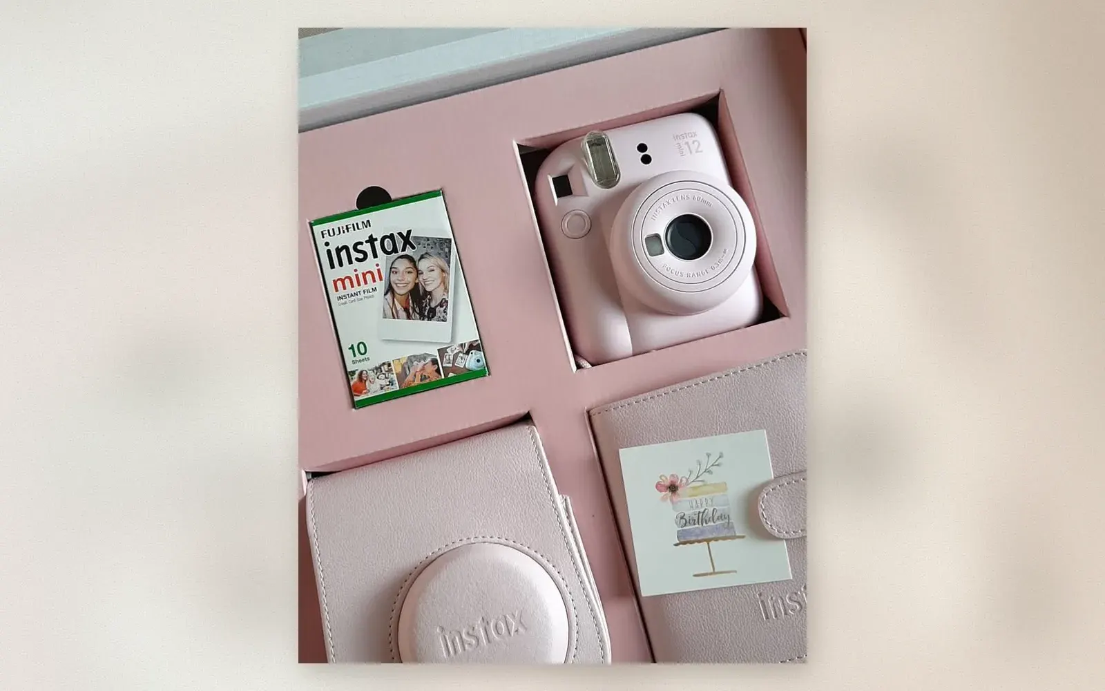 Fujifilm Instax Mini 12 Blossom Pink gift set with camera, film, case, and photo album in the box
