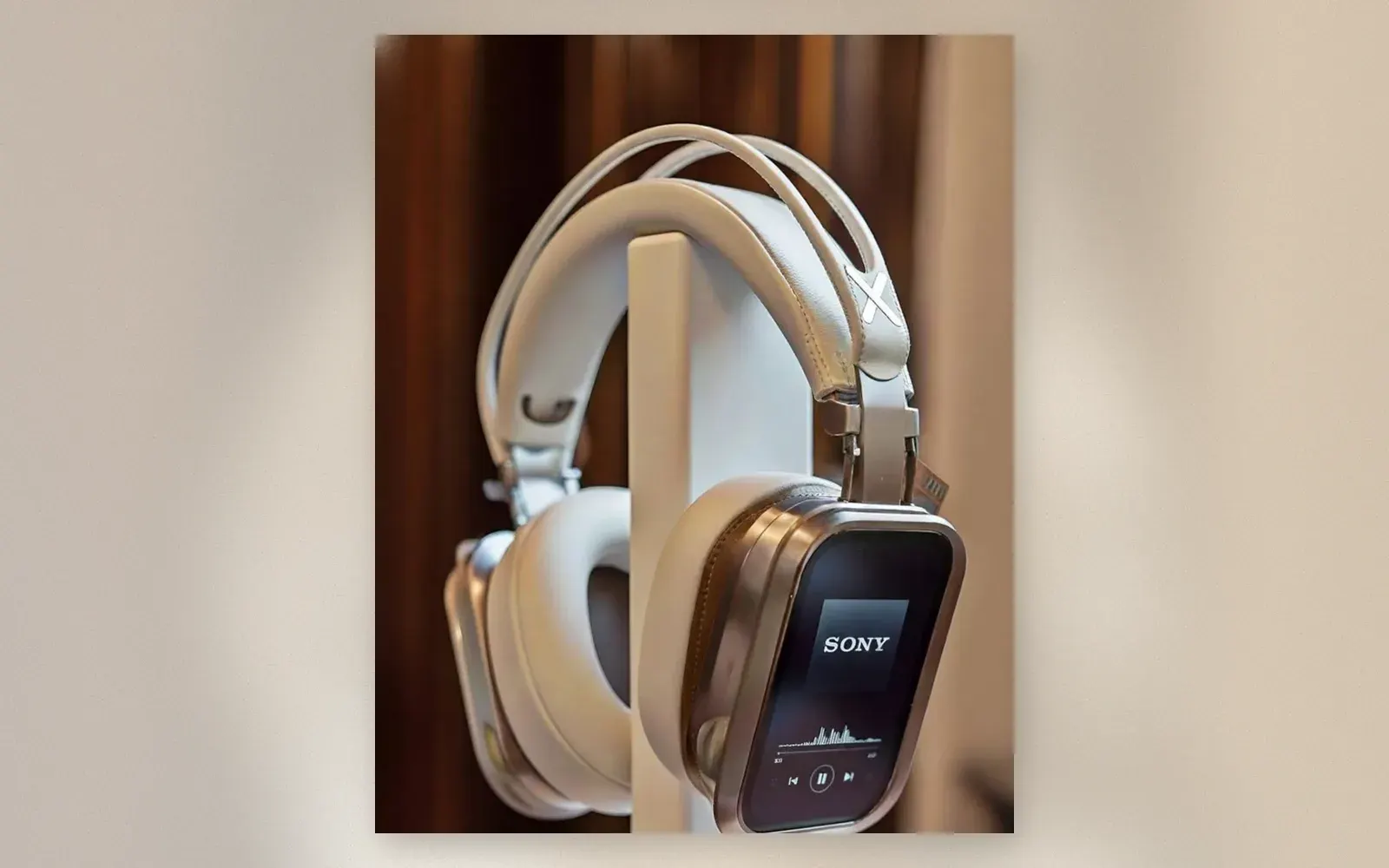 White premium over-ear headphones displayed on a white pedestal stand with metal plate