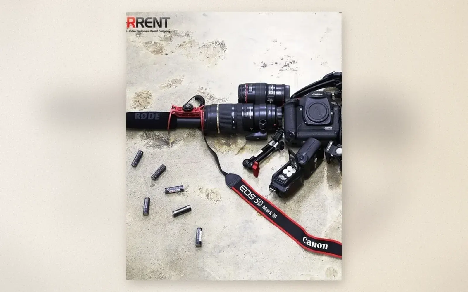 Canon 5D Mark III video rig flat lay with Rode microphone, battery grip, telephoto lenses, and a speedlite