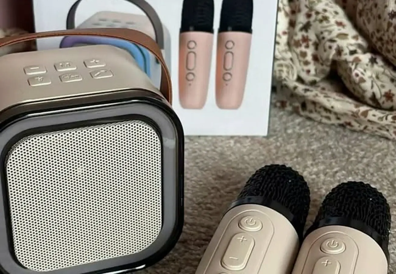 Cream K12 karaoke machine speaker with its box and two wireless microphones