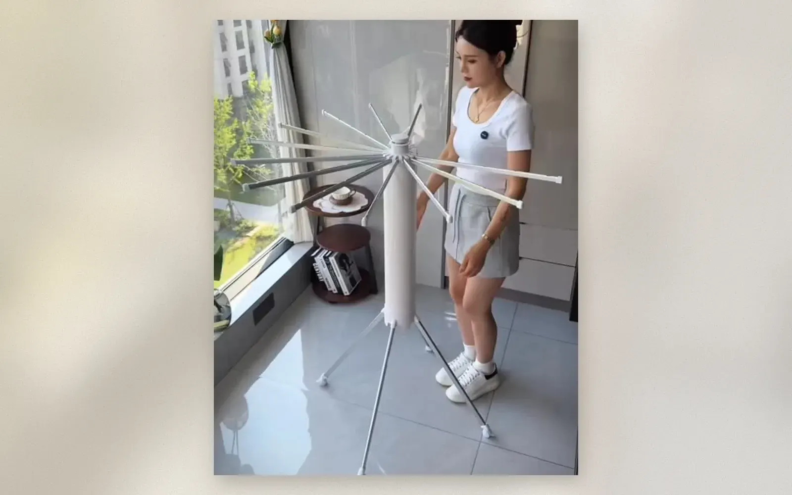 Umbrella clothes drying rack with radiating arms on tripod base with wheels
