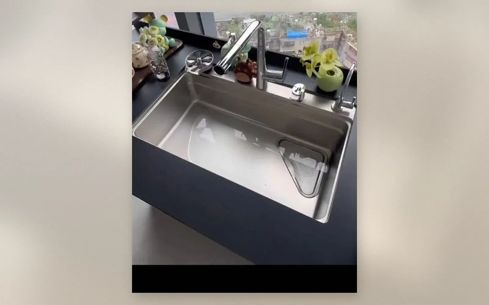 Close-up of the triangular colander and strainer basket in the sink basin
