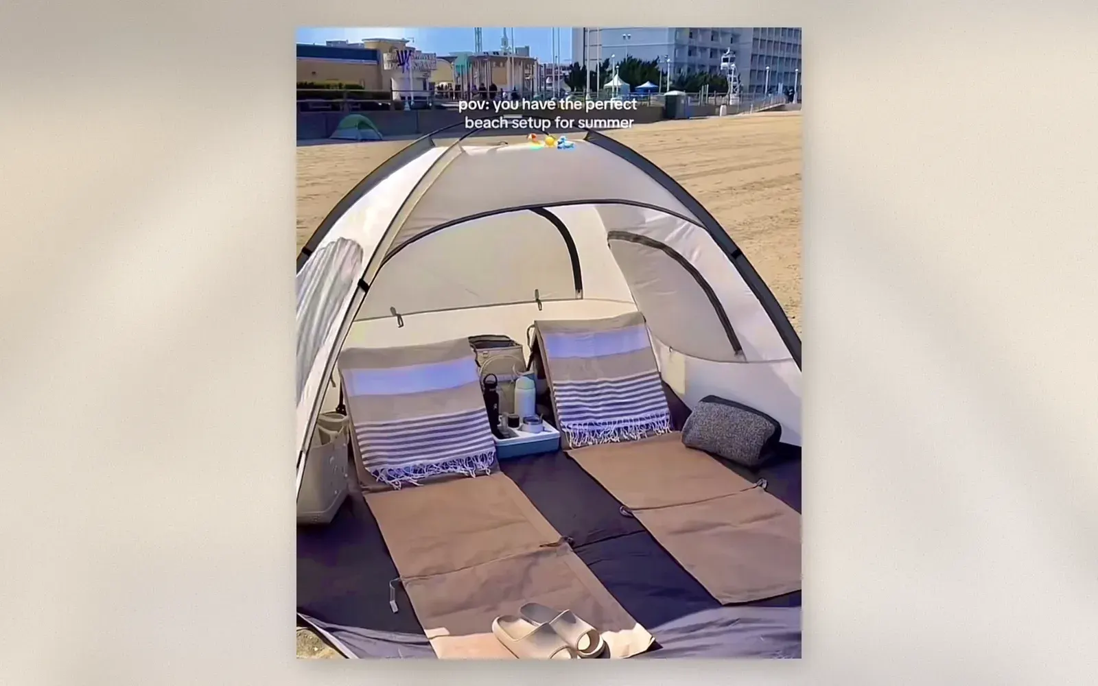Beach tent cabana on sand with extended floor and beach accessories inside