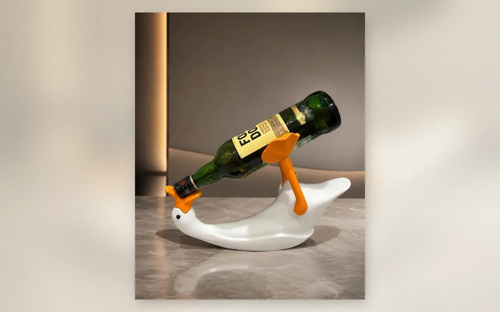 Close-up of the duck’s beak supporting the wine bottle