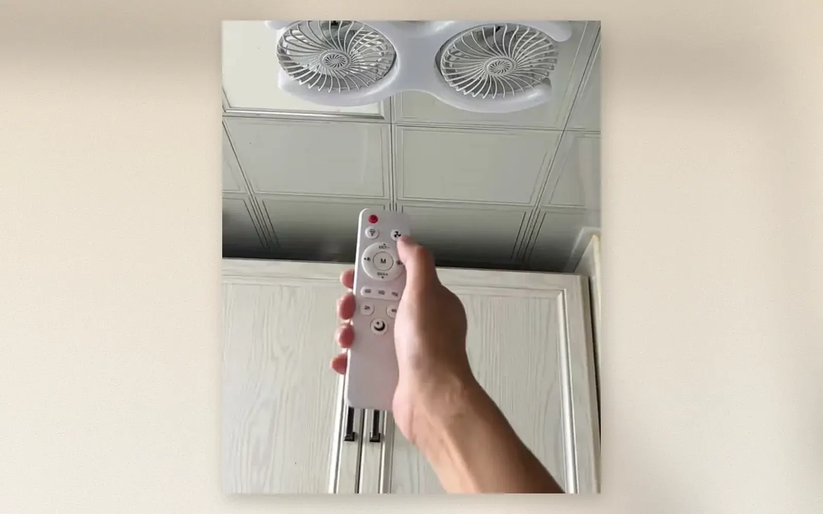 Dual-head ceiling fan with remote control mounted on ceiling