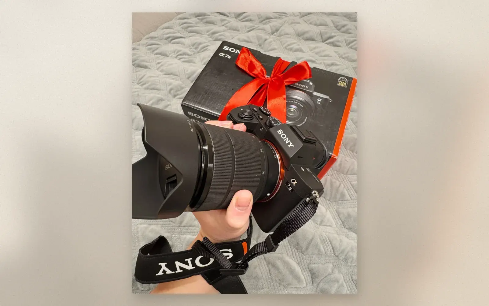 Sony A7III with FE 28-70mm kit lens and red bow on original box