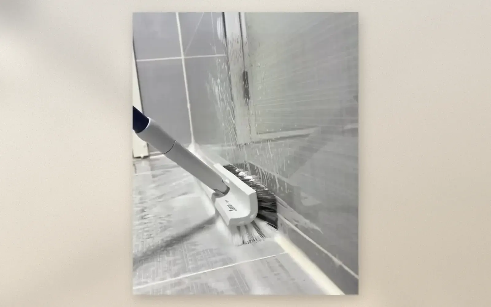 Corner cleaning brush scrubbing baseboard grout lines with stiff bristles