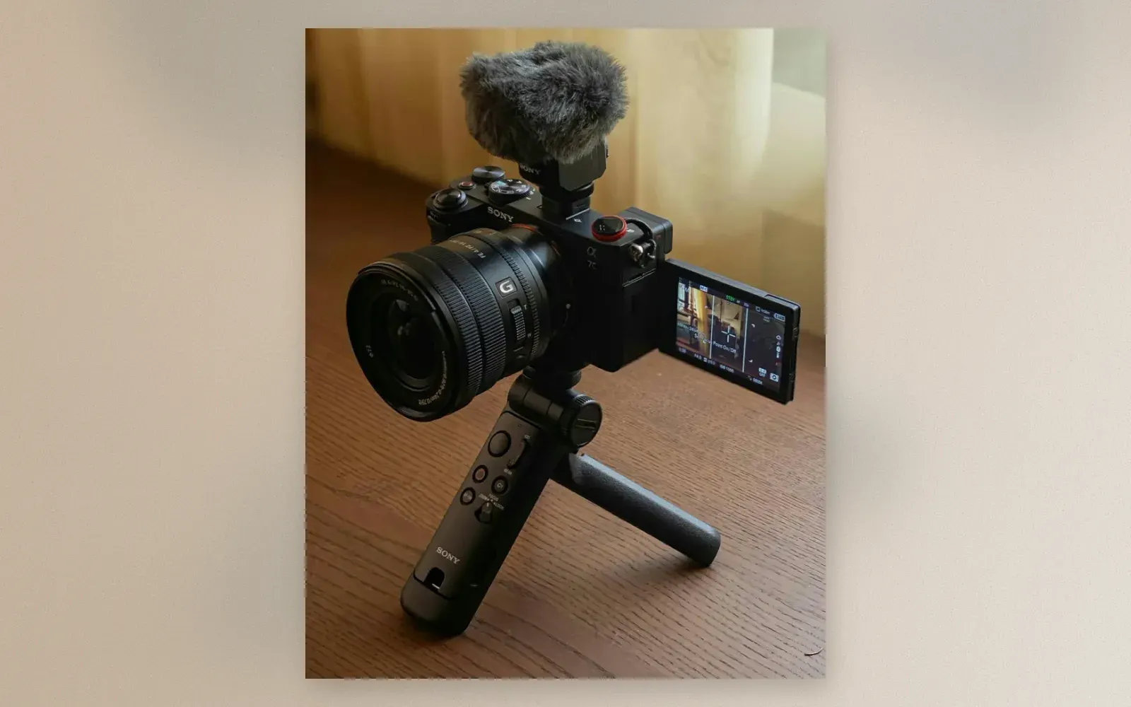 Sony A7C with power zoom lens, shotgun mic, and GP-VPT2BT grip on a wooden table