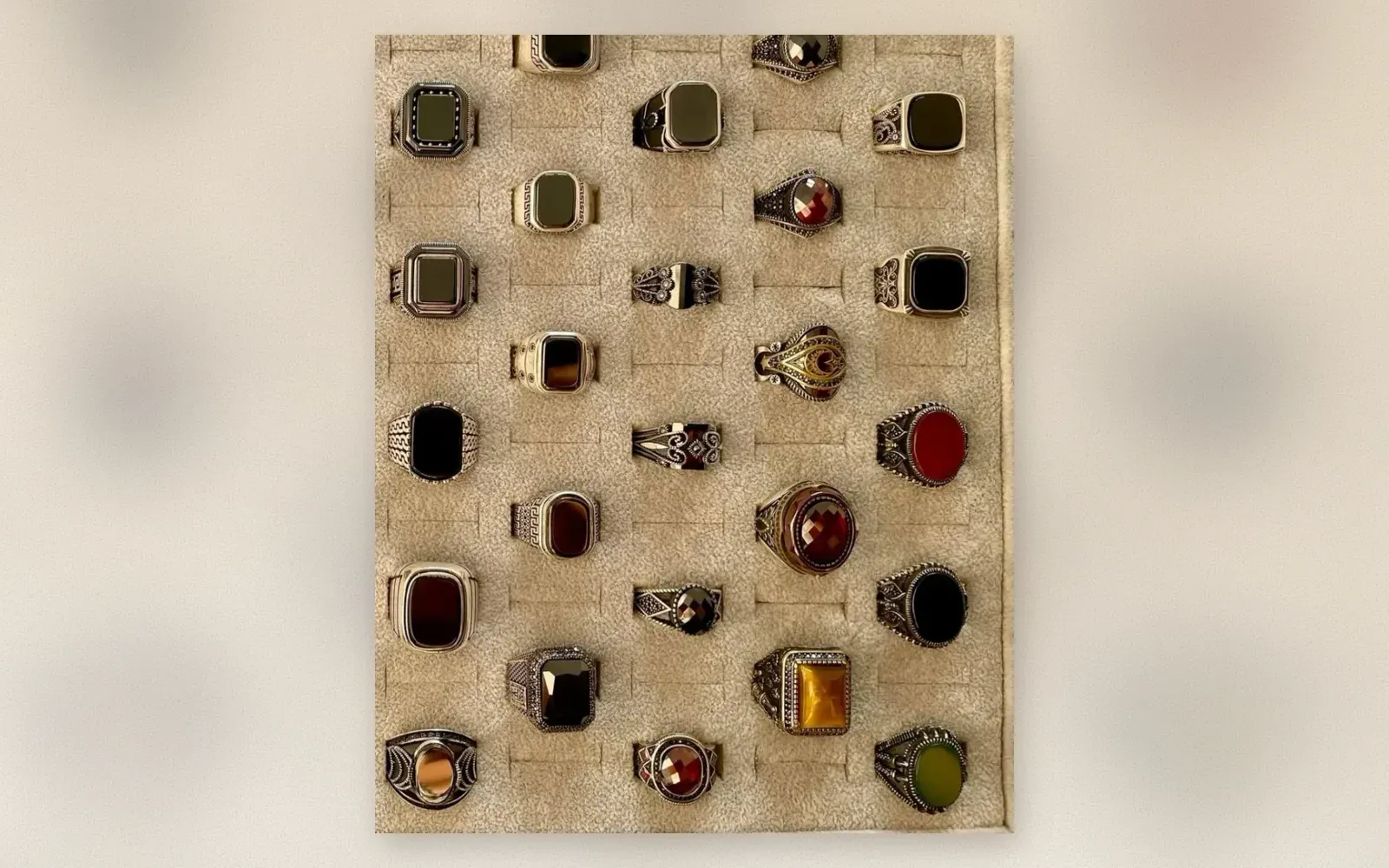 Tray of Ottoman-style 925 silver men's signet rings with onyx, amber, garnet, and tiger eye stones