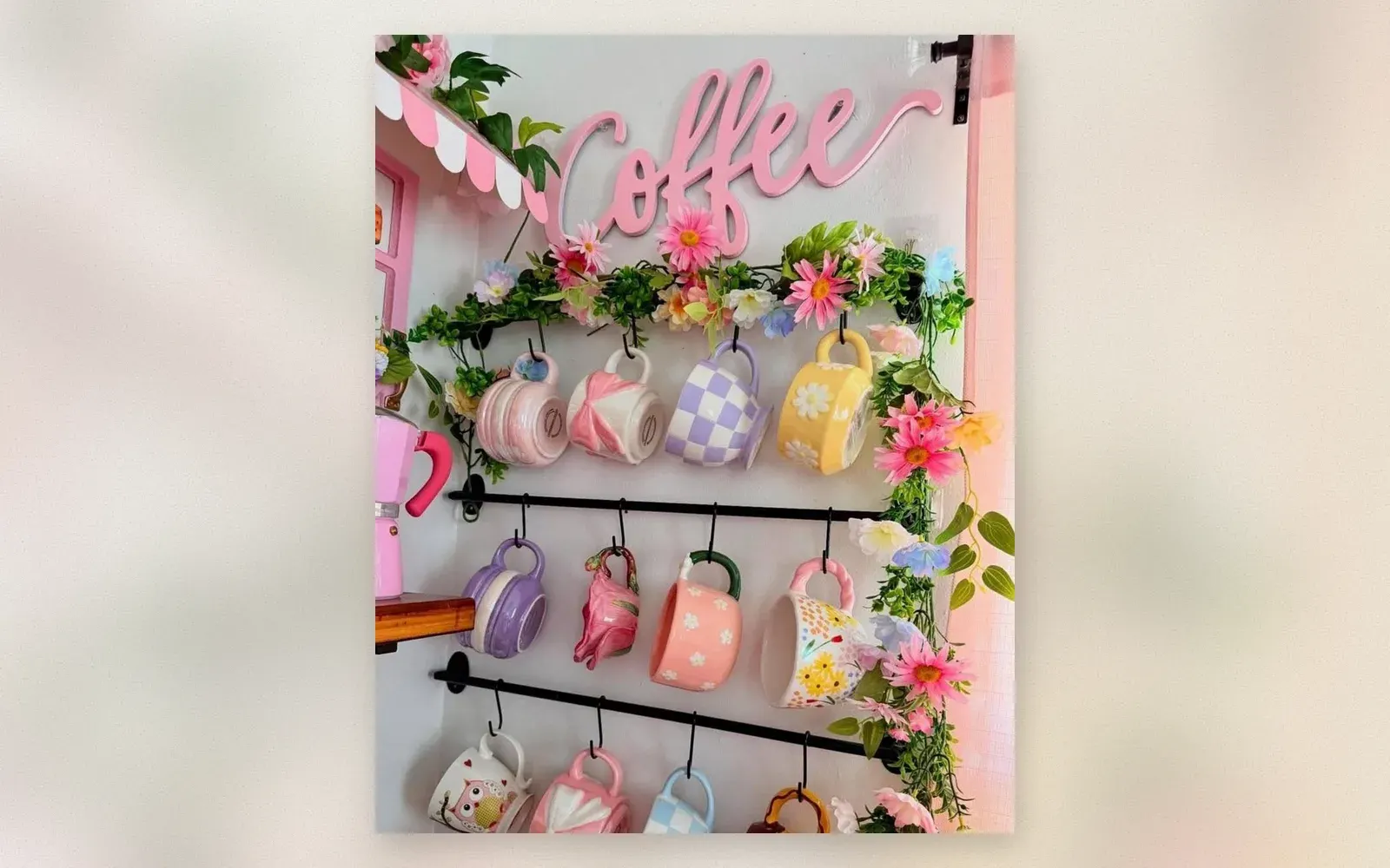 Wall-mounted mug rack with 3 tiers holding colorful mugs and coffee sign
