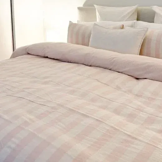 Close up of the pink and white check washed cotton duvet cover fabric