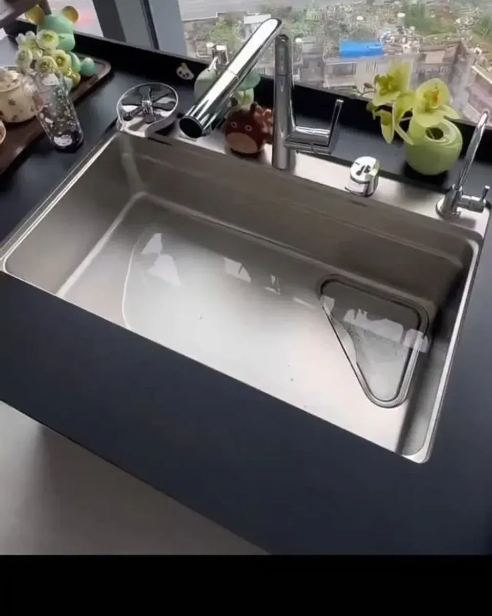 Close-up of the triangular colander and strainer basket in the sink basin