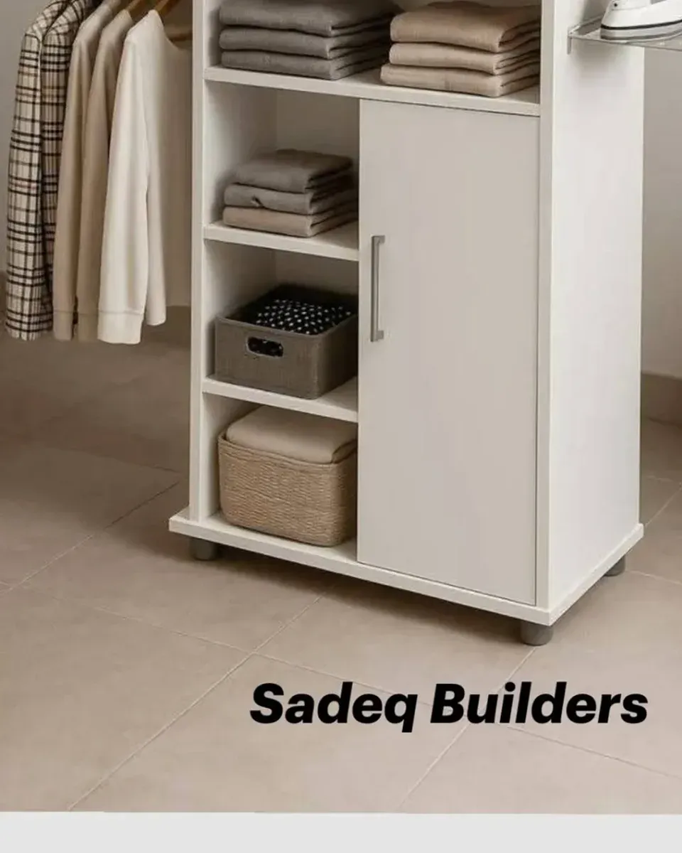 Close-up of the hanging rail and folded clothes on shelves