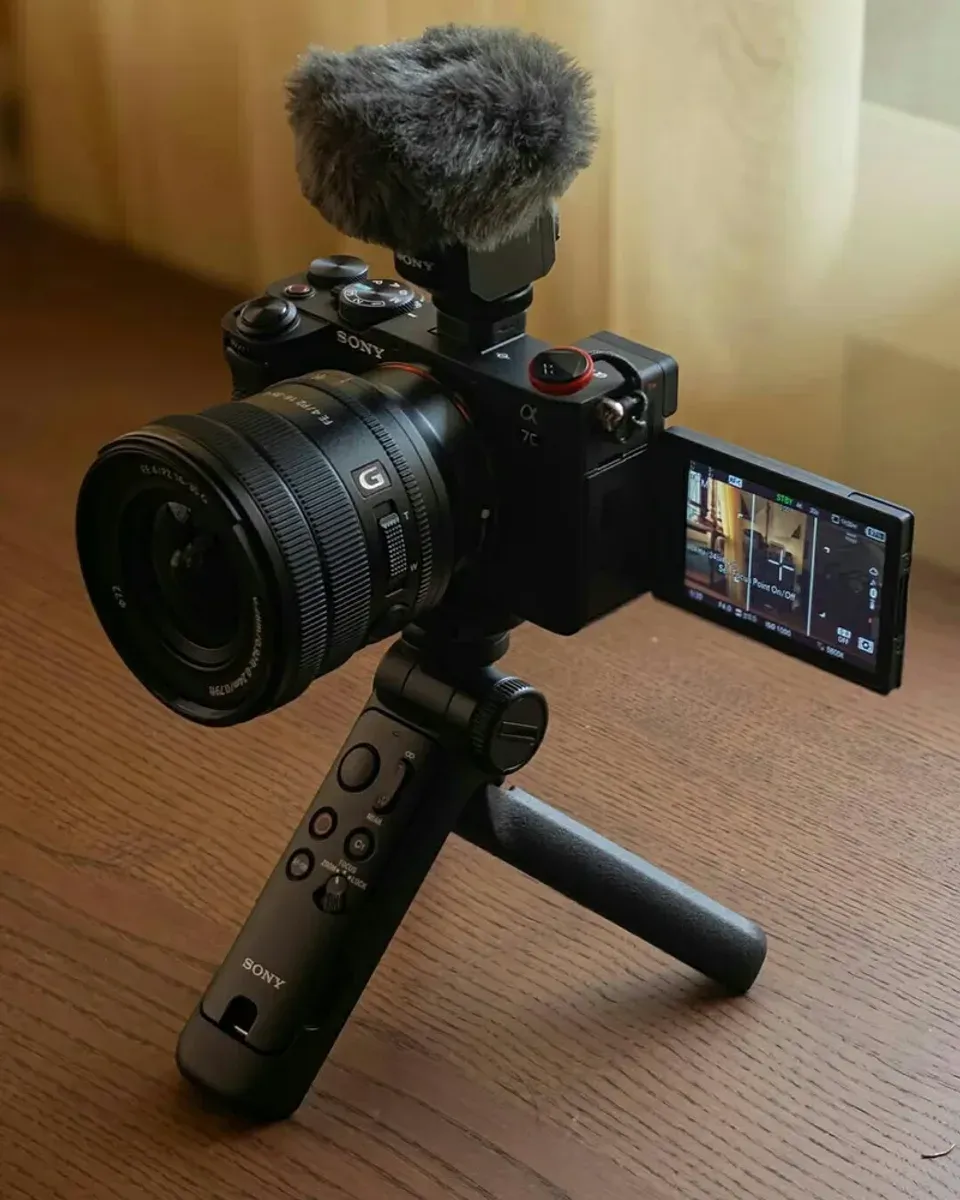 Grip detail showing zoom rocker, record button, and tripod legs