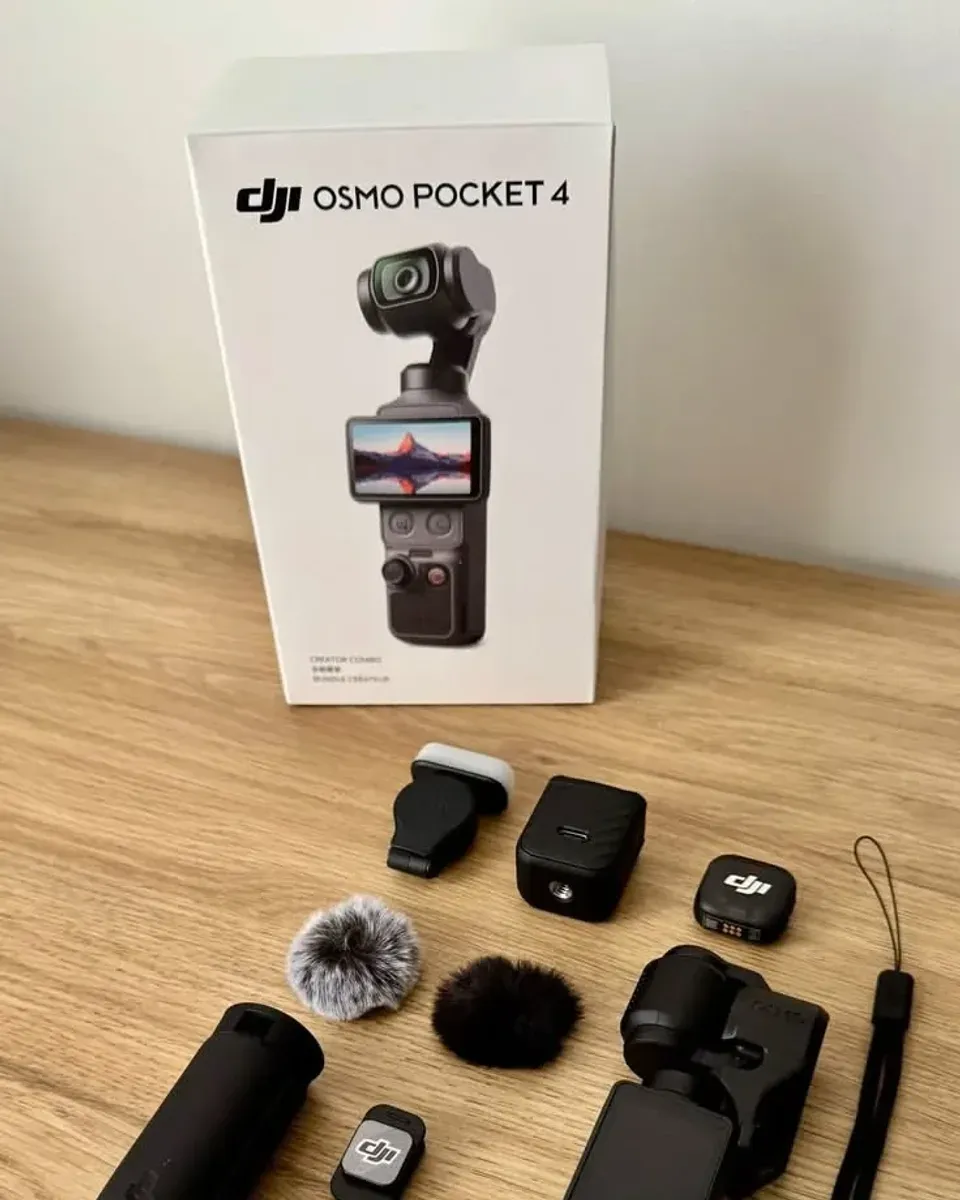 DJI Osmo Pocket 4 Creator Combo seen straight on with the mic transmitter, fill light, and windscreens in front