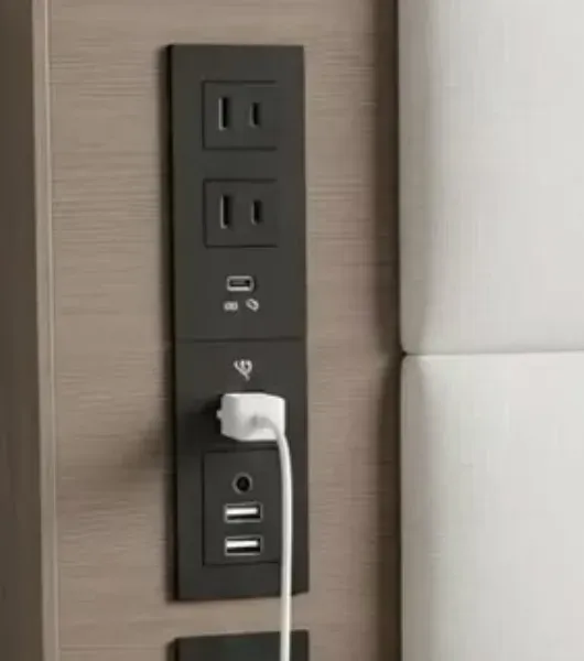 Close up of the recessed panel with two sockets and a USB-C plus USB-A port inside a wooden headboard