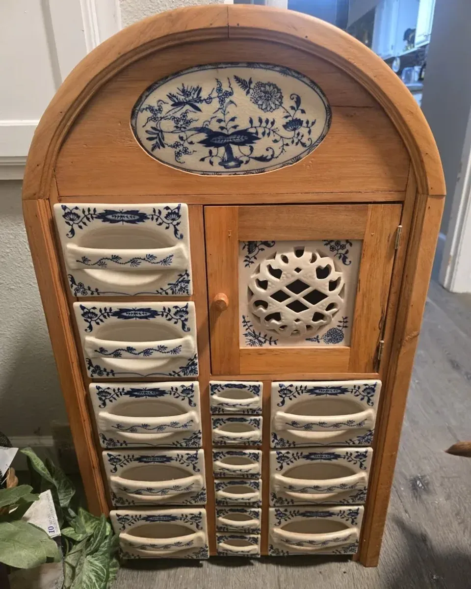 Close-up of the ceramic drawer fronts showing the blue and white Delft patterns