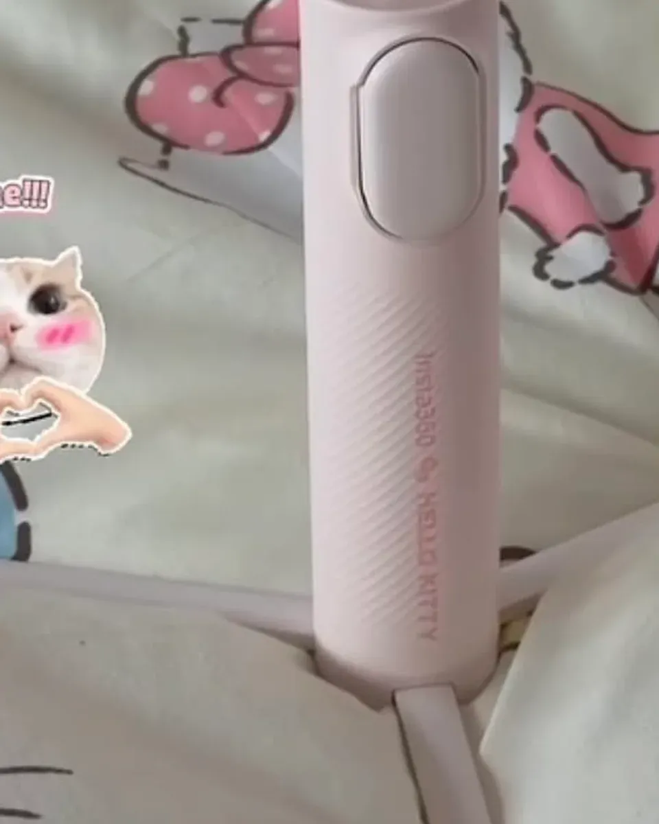 Insta360 GO Ultra Hello Kitty camera standing on the tripod legs