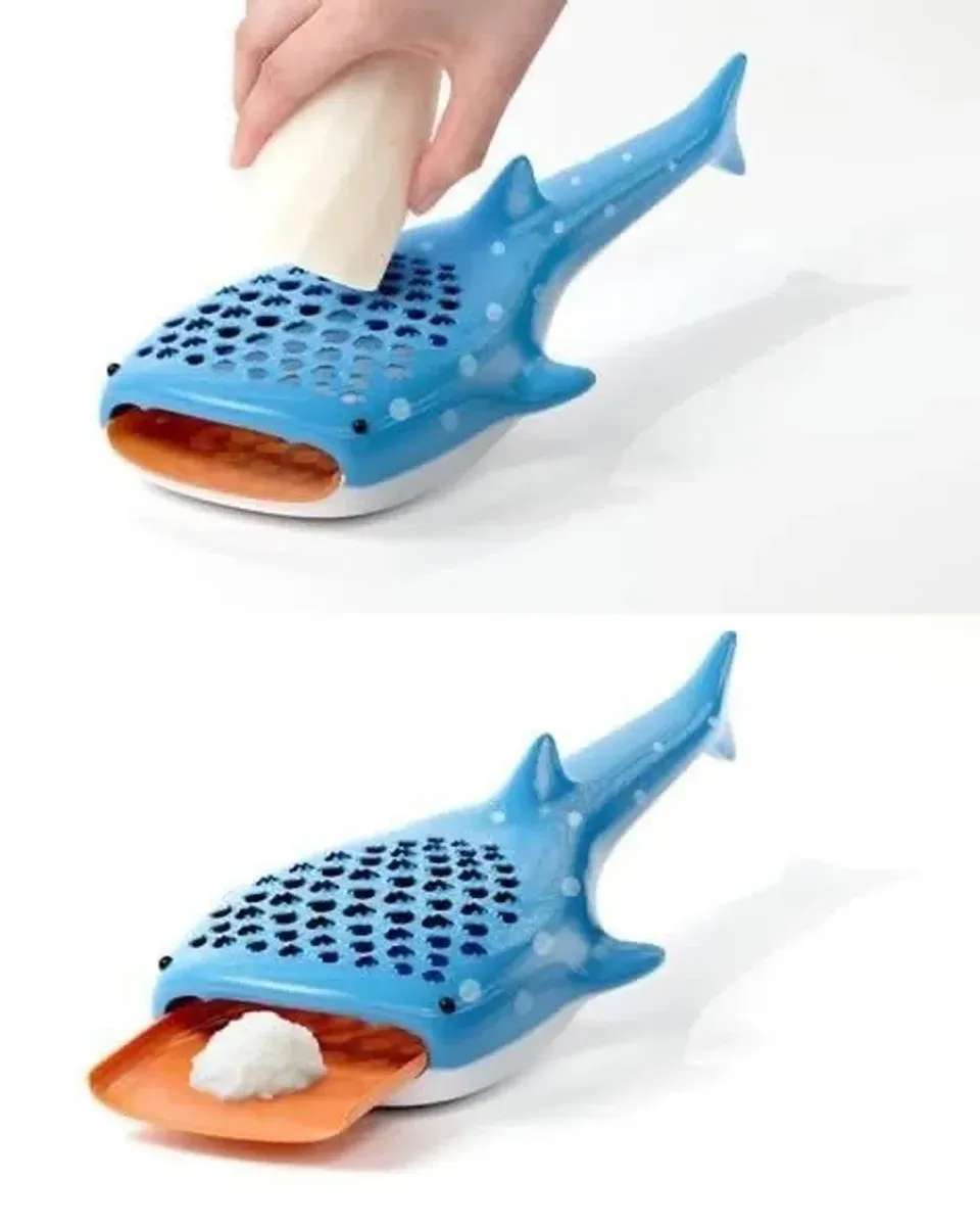 Whale shark grater catch tray filled with freshly grated cheese