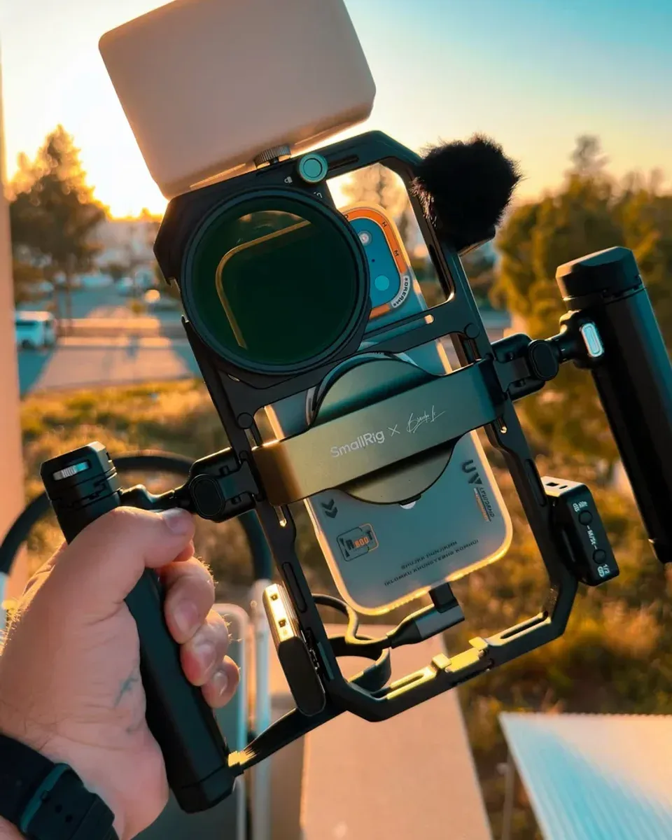 Rig detail showing wireless mic, LED panel, and rotating grip arm