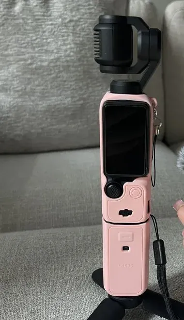Osmo Pocket 3 pink case close-up showing the silicone texture and attached wrist strap
