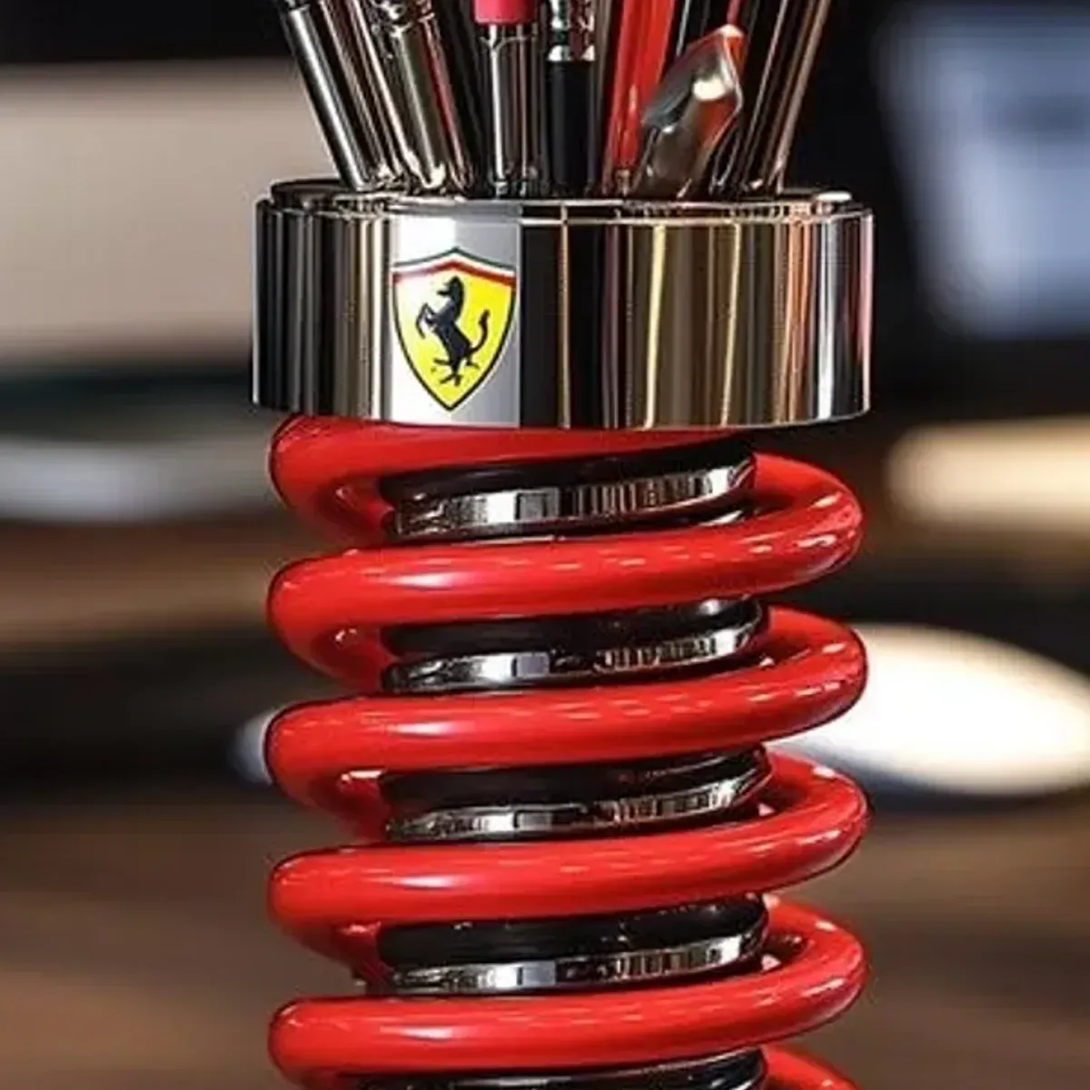 Detail of the prancing horse badge on the chrome band of the pen holder