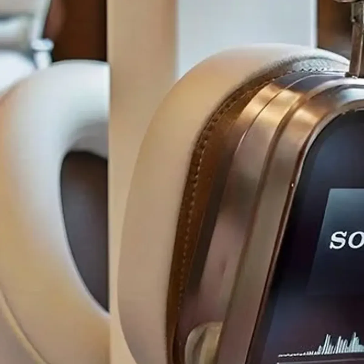Headphones on wall mount above a desk