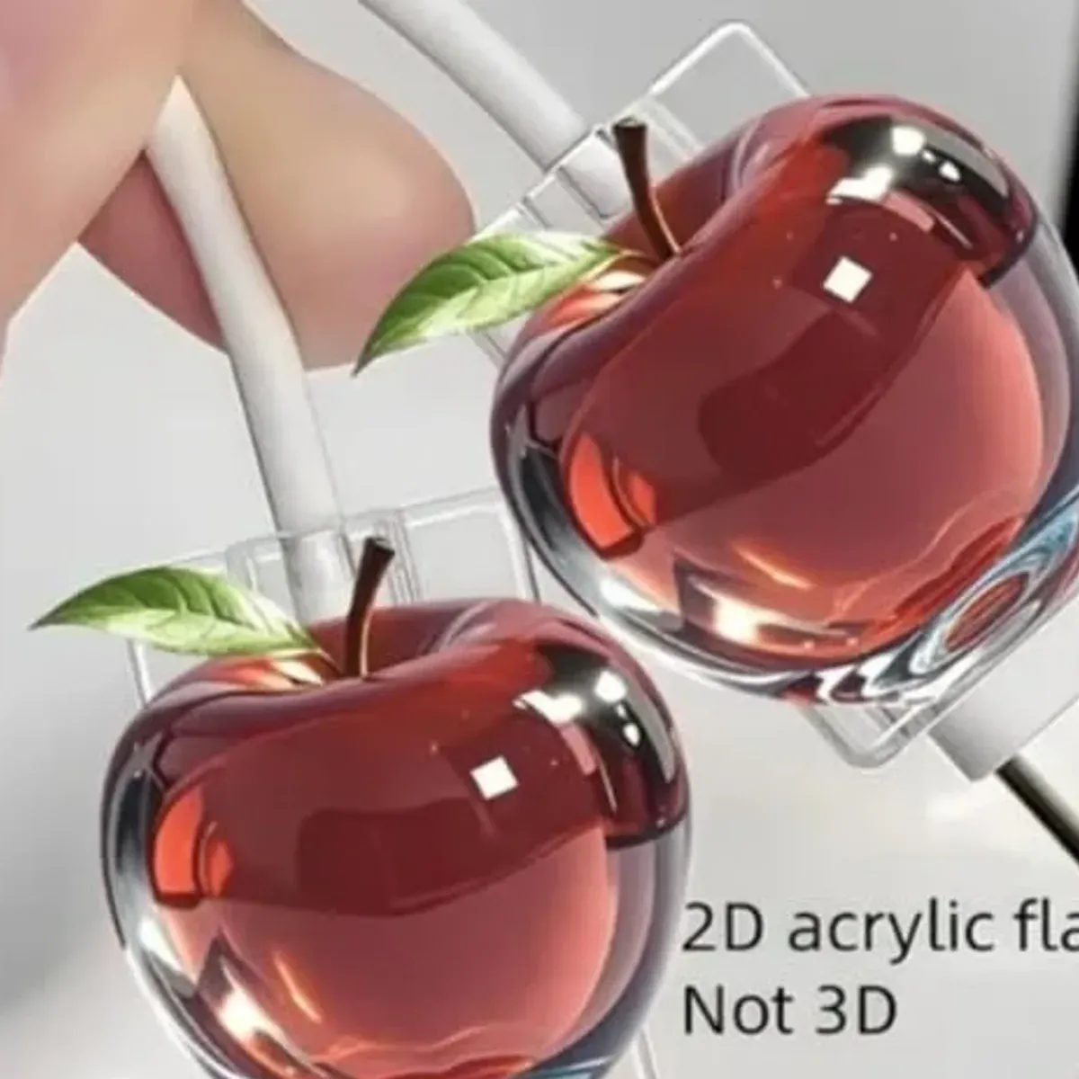 Close up of the red apple acrylic charm showing the flat design and glossy print finish