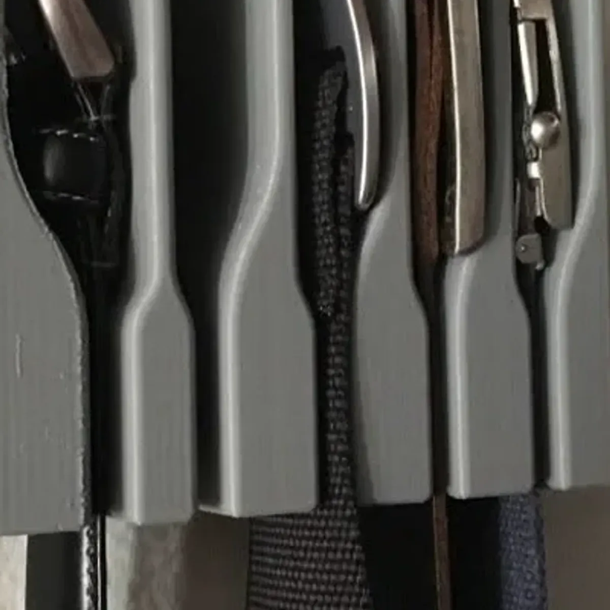 Wall-mount belt hanger installed inside a closet door