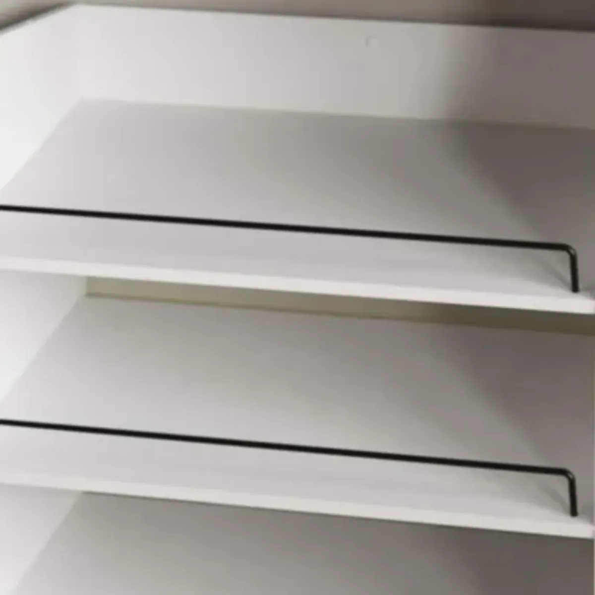 Closet shelf organizer insert installed in a wardrobe showing clothes hanging above