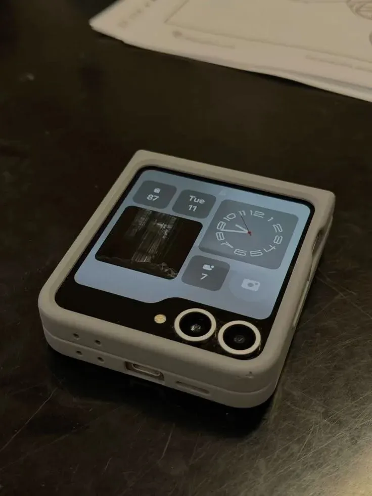 Samsung Galaxy Z Flip 7 half-folded in Flex Mode with cover screen widgets