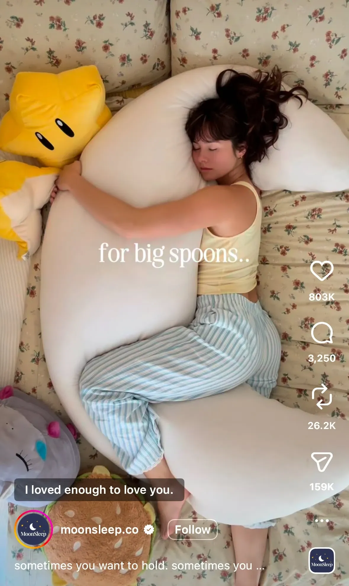 Side sleeper hugging the giant crescent moon body pillow