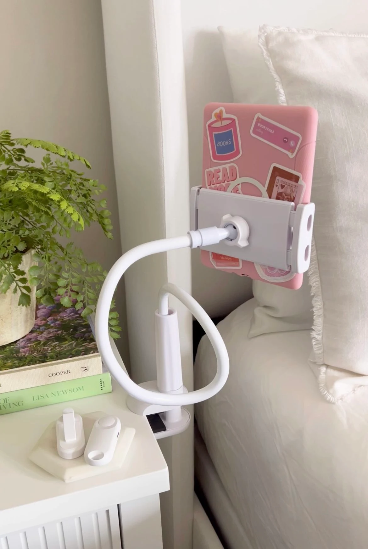 Gooseneck tablet holder with a 12.9 inch iPad mounted in black, on a bedside clamp