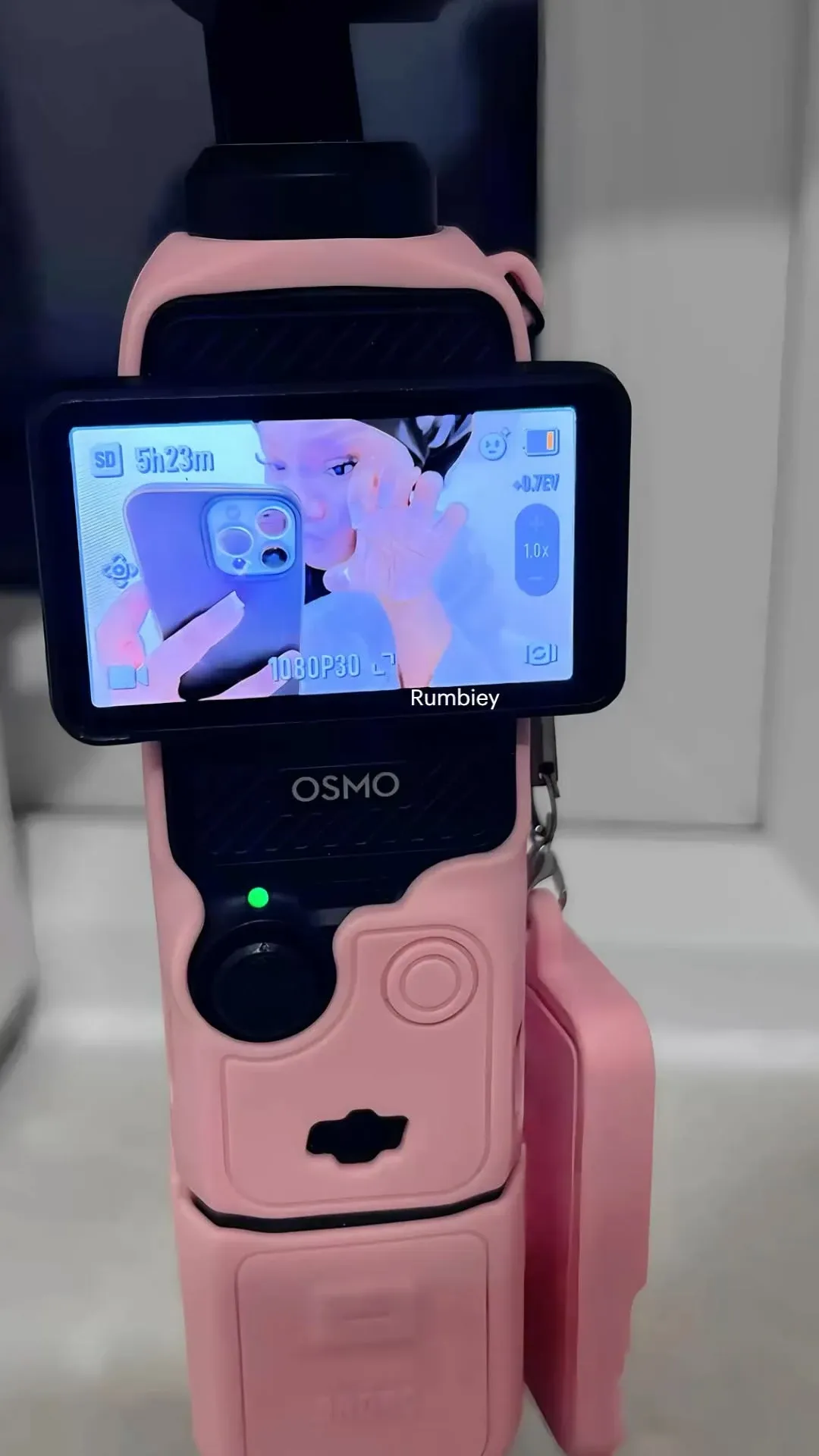 DJI Osmo Pocket 3 in a pink silicone case on a mini tripod