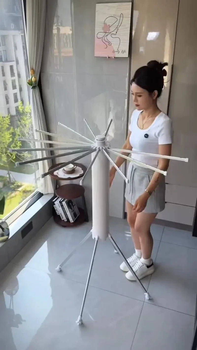 Umbrella clothes drying rack showing the radiating arms and tripod base