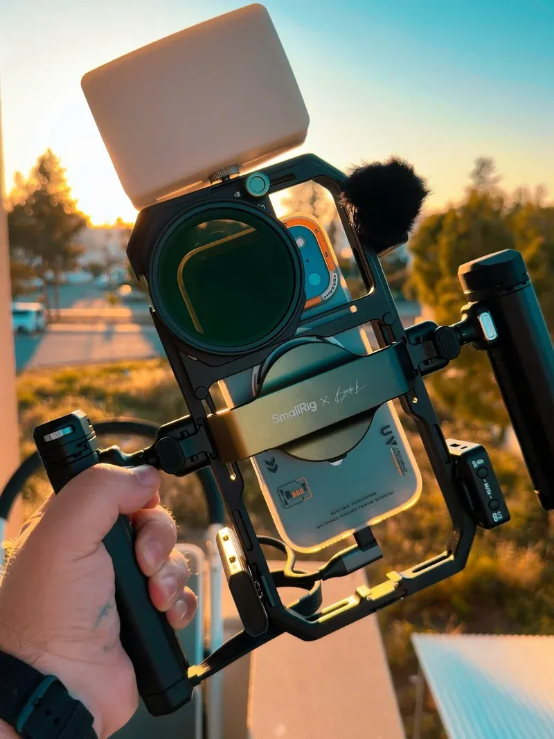 SmallRig x Brandon Li rig in hand with phone, filter, mic, and LED at sunset