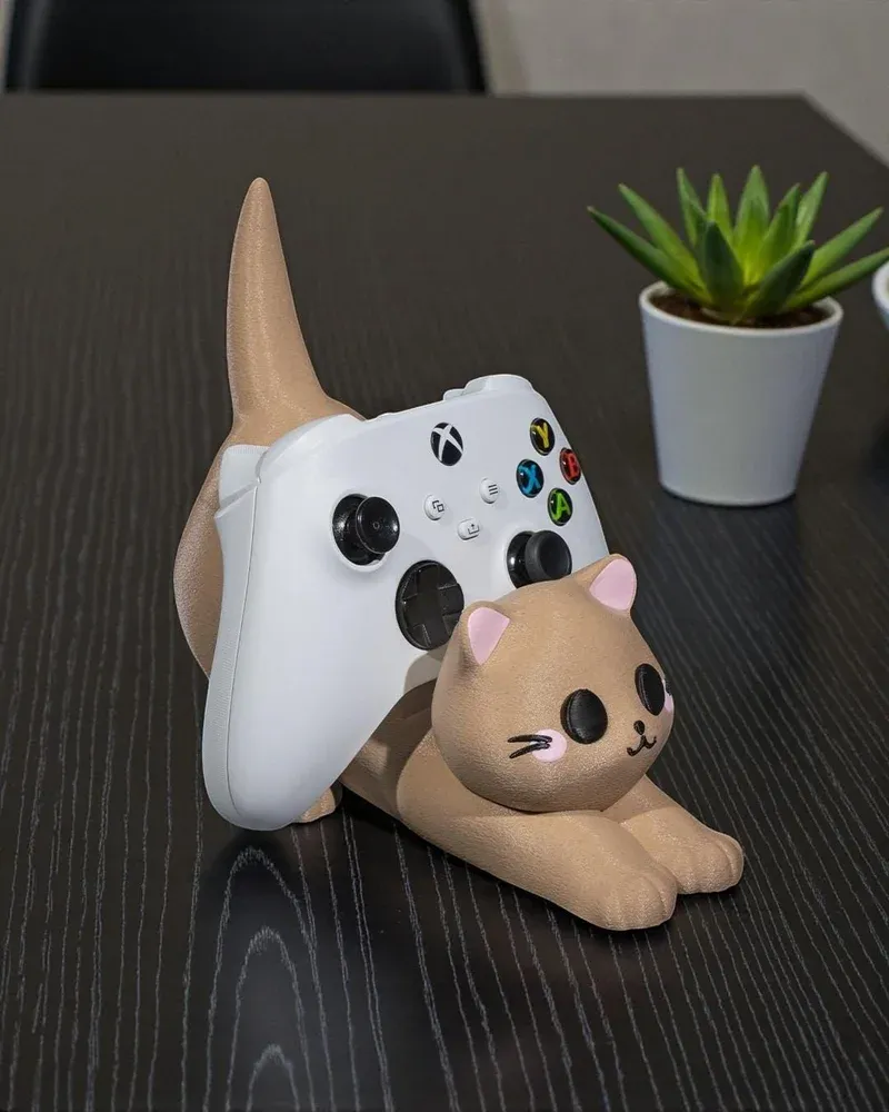 Cat game controller stand showing the Xbox controller resting on the arched back
