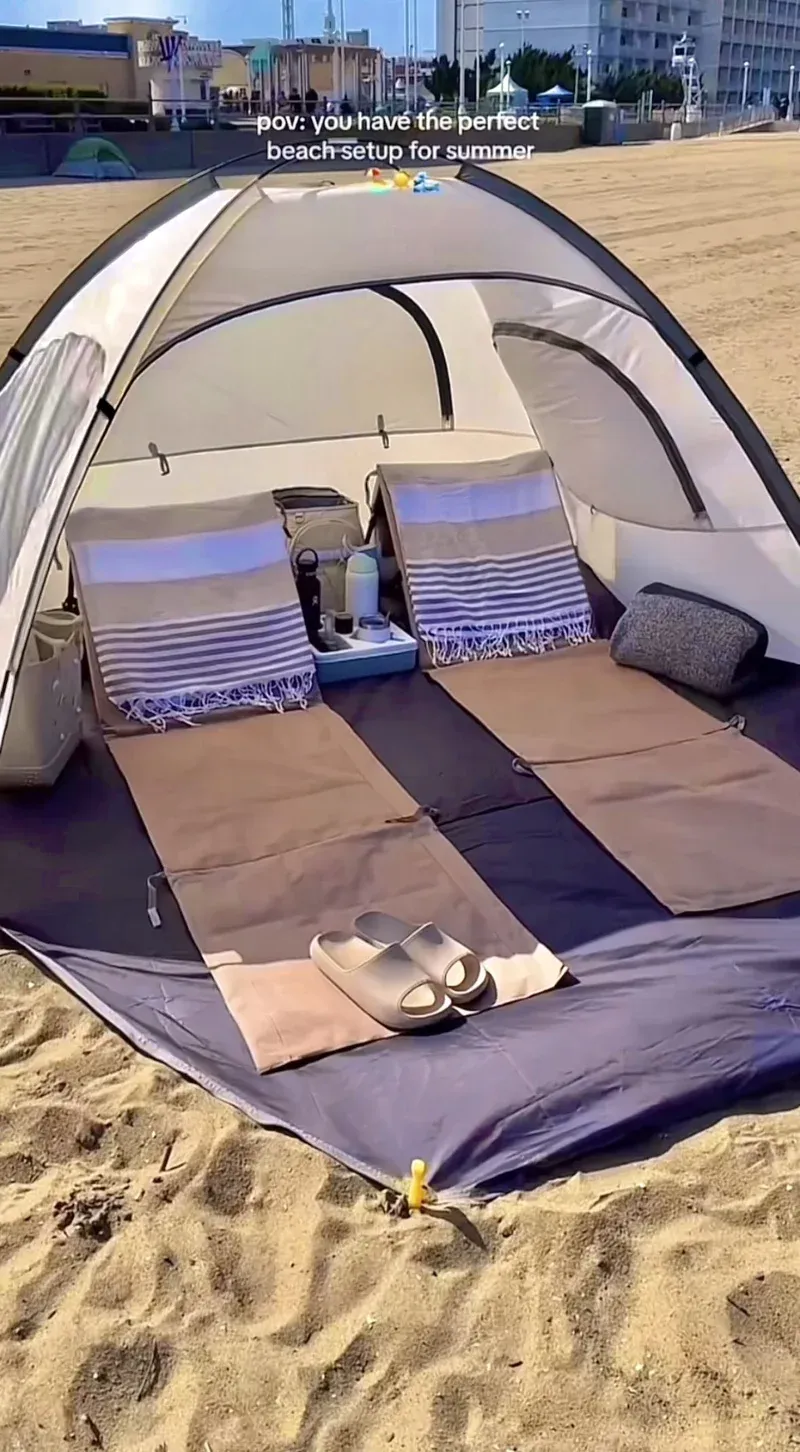 Beach tent cabana set up on sand showing the open front and extended floor