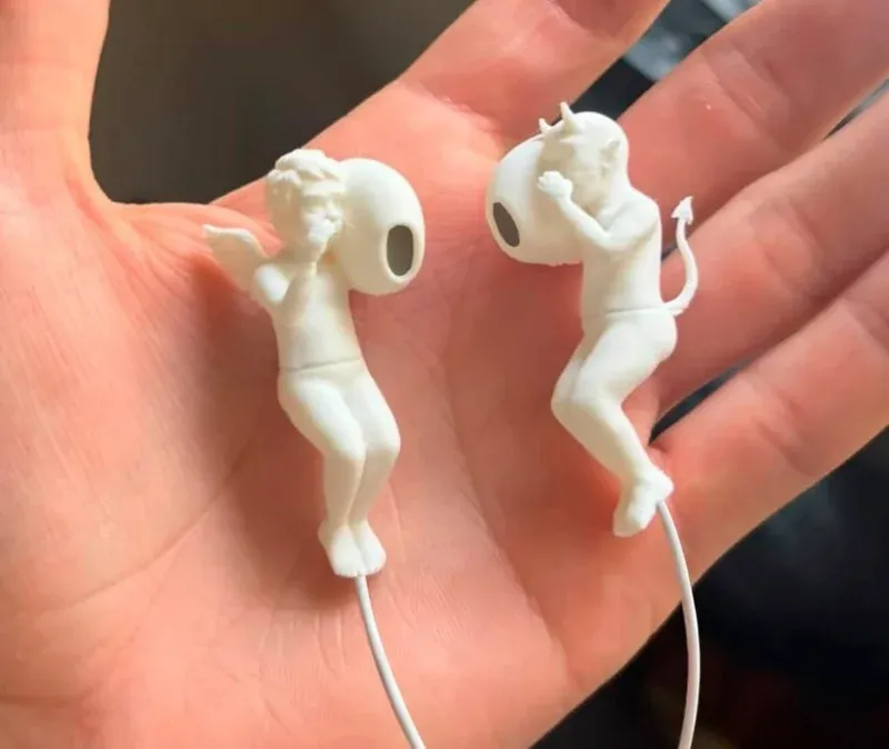 Angel and devil AirPods clips showing the figurines on earbuds