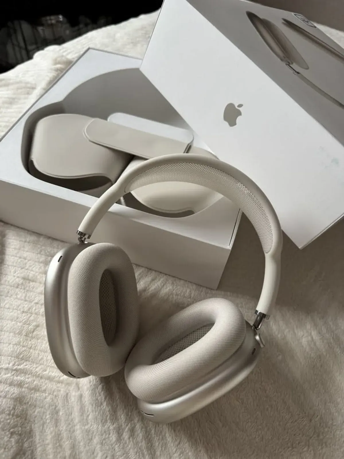 Apple AirPods Max in Starlight shown from the side with the knit-mesh headband visible
