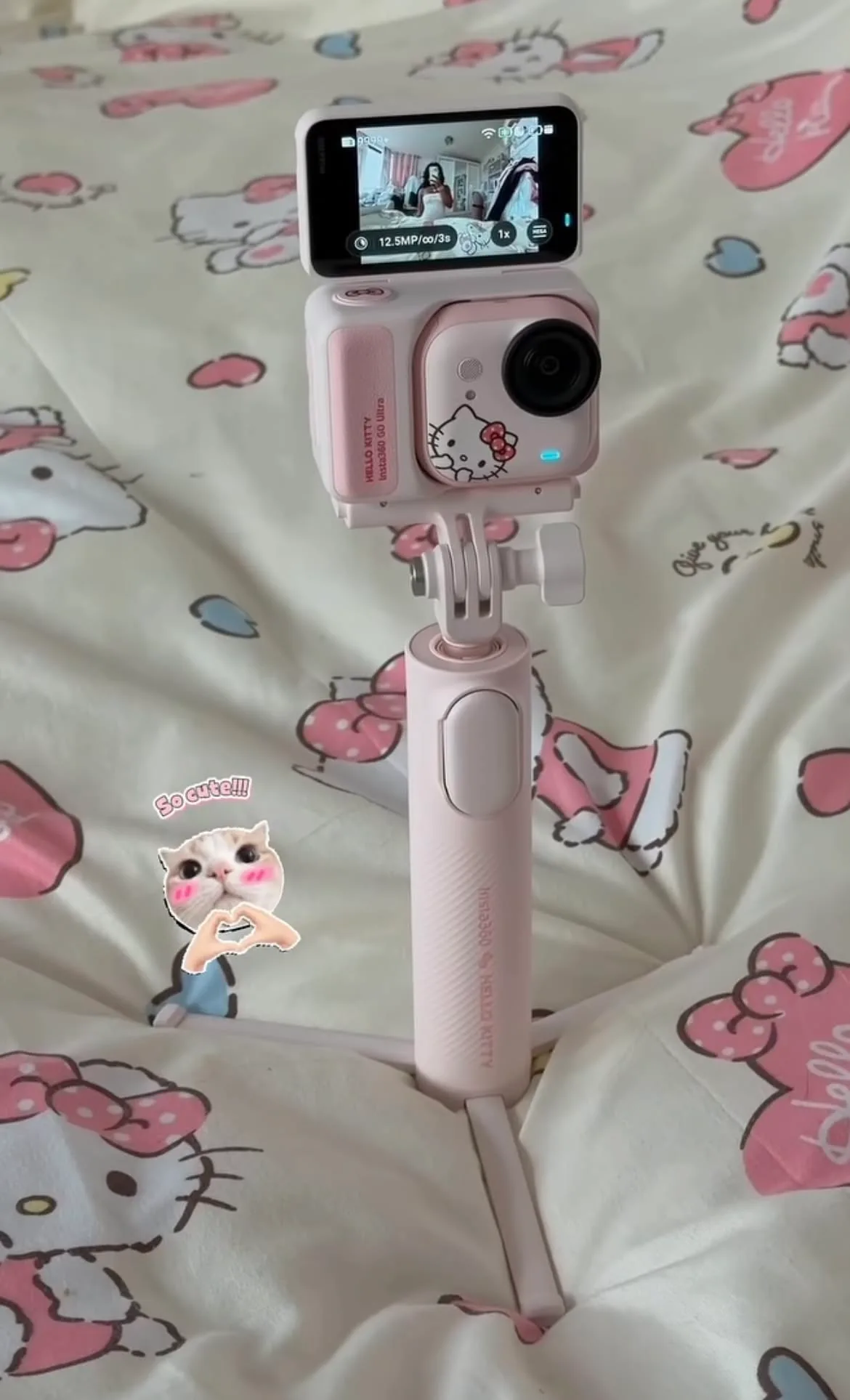 Insta360 GO Ultra Hello Kitty camera on the pink grip handle with tripod legs folded out
