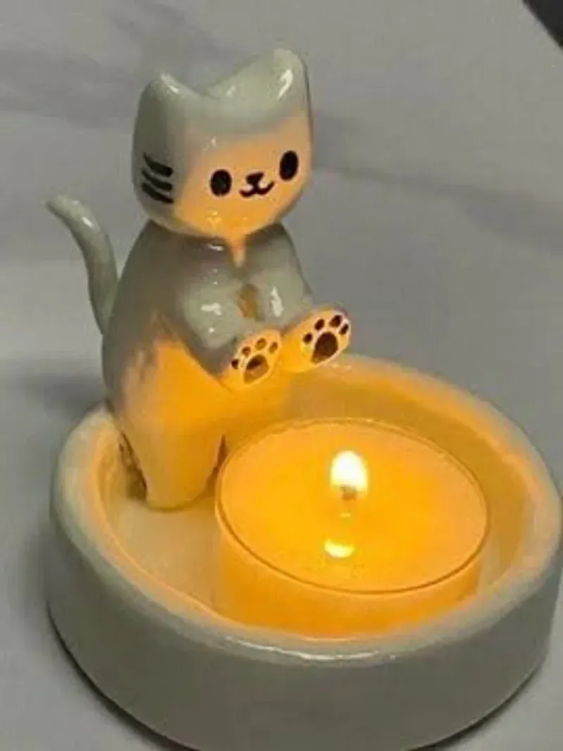 Ceramic cat candle holder showing the kitten sitting on the tealight dish