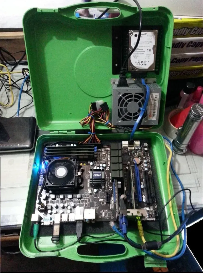 MSI motherboard mounted inside the green toolbox bottom half